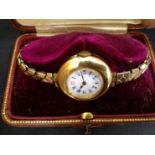 An 18ct gold wristwatch on gold plated expanding bracelet. (boxed).