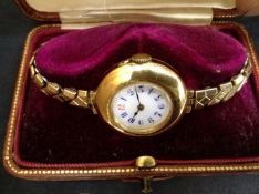 An 18ct gold wristwatch on gold plated expanding bracelet. (boxed).