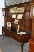 An 18th Century and later country oak dresser with shelves to back. 202cm wide. 200cm high. 53cm