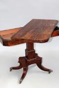 A William IV rosewood fold over card table on square form column with platform and sabre legs.