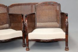 A mahogany three piece bergere suite comprising a two seater and a pair of armchairs. Each piece