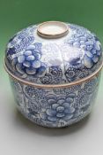 A Chinese blue and white potiche and cover decorated with a flowery chrysanthemum pattern. 22cm high