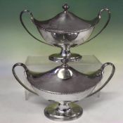 A pair of Contemporary silver sauce tureens and covers with beaded rims and oval pedestals. London