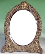 A silver gilt easel dressing table mirror by William Comyns, London 1898. The embossed and pierced