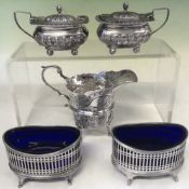 A pair of pierced oval silver table salts. London 1906, a pair of silver mustard pots. Birmingham