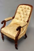 A William IV carved rosewood library armchair with scroll arms and button back, turned legs end in