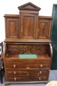 A Continental 19th Century pine cylinder form bureau cabinet. Of architectural form. Faux walnut
