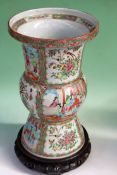 A Chinese export Cantonese beaker form tall vase. Figural panels. Surrounded by flowers, birds and