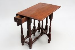 An 18th Century and later oak small gateleg cottage table with end drawer on turned legs and