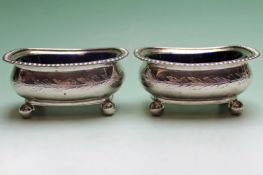 A pair of George III silver table salts with Bristol blue glass liners. M&R.