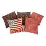GROUP OF FIVE ASSORTED PILLOWS Two with a paisley pattern, two with a lozenge design, and one with