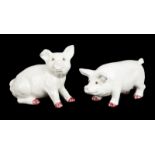 PAIR OF WHITE TERRACOTTA PIGS A pair of white painted terracotta pigs with glass eyes.Larger, 10