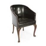 ANTIQUE LEATHER BARREL CHAIR An antique leather covered barrel chair with carved knees and slipper