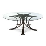 STAR DINING TABLE A star form silver top dining table on an iron base, with a round plate glass