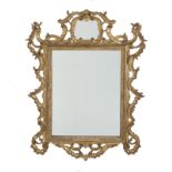 ANTIQUE MIRROR An antique mirror with gilt carved wood frame and mirrored cartouche crest.