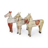 GROUP OF THREE CAROUSEL HORSES A group of three painted wooden decorative child-size carousel