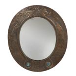 ART NOUVEAU MIRROR An oval hammered copper Art Nouveau wall mirror with serpent-form decoration