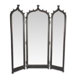 STANDING THREE-PART MIRROR With carved ebonized parcel gilt wood frame, shaped beveled glass, and