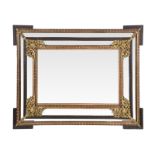 ANTIQUE MIRROR A carved stained and blond wood frame with gilt metal decoration and side panels.