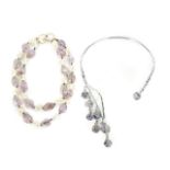 JOAN COLLINS AMETHYST TONE NECKLACES A pair of amethyst tone necklaces: a double-strand necklace