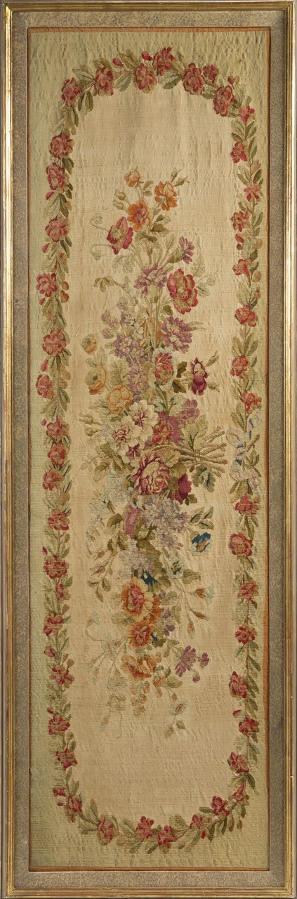 JOAN COLLINS ANTIQUE FLORAL TAPESTRY An antique oblong floral tapestry mounted on board and framed.