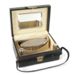 JOAN COLLINS VINTAGE TRAVELING VANITY CASE A vintage leather traveling vanity case with silk