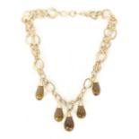 JOAN COLLINS ITALIAN GOLD NECKLACE A 14kt gold necklace with dangling amber-colored faceted glass