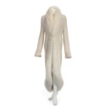 JOAN COLLINS FUR TRIMMED SWEATER A long ivory knit sweater with white fox fur trim worn by Joan