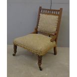 Late Victorian Ladies Nursing Chair on turned supports with castors, galleried top rail, padded back