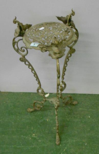 Brass Tri Footed Plant Stand with monkey mask detail, c-scroll decoration