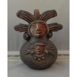 Chilean Pottery Figure, signed to base Ernest Duran? with facial masks in white & terracotta wearing