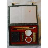 Boxed Chinese Calligraphy Kit with ink blocks, soapstone seal, mixing bowl, brushes etc. in silk