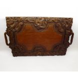 A large Oriental Hardwood Carved Tray, decorated with dragons and geometric designs etc, 25” wide