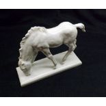 A Dresden Blanc de Chine Model of a Horse standing on an integral plinth (ears chipped), cross