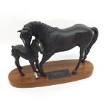 A Beswick Connoisseur Model, Black Beauty and Foal, raised on oval wooden plinth base, 8” high