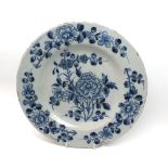 A European Delft Circular Plate, painted in underglaze blue with scrolling foliage (rim chip and