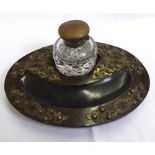 A late 19th or early 20th Century Oval Hardwood Desk Stand with brass floral decoration, clear glass