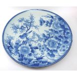 A Chinese large Charger, decorated in under glazed blue with bird perched amidst foliage, the