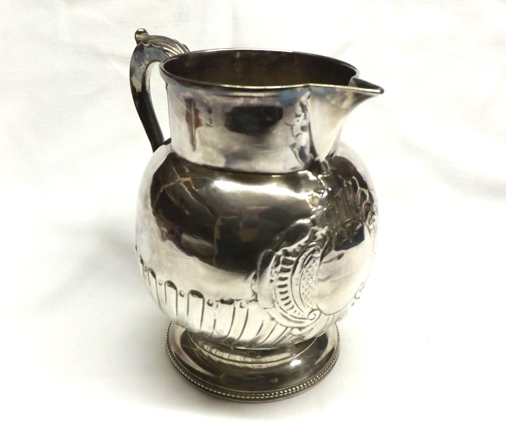 A George III Silver Baluster Jug with later wrythen fluted and cartouche decoration, leaf capped