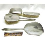 A Four Piece Silver Backed Dressing Table Set comprising Hand Mirror, Three Brushes and a Comb,