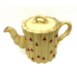 A Wedgwood Queens Ware Cane Ware Teapot and Cover, moulded pate sur pate and decorated in red with