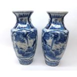 A pair of blue Imari baluster Vases typically decorated in under glazed blue with panels of scenes