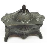 A WMF Pewter Dressing Table Trinket Box of serpentine form, the body decorated with stylised foliage