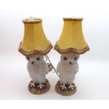 An unusual pair of Ceramic Table Lamps formed as snowy owls, raised on plinth bases, fitted with