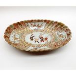 An Imari or Arita Oval Bowl of fluted form, painted predominantly in iron red with gilded detail,