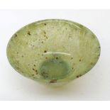 A small circular Jade Bowl of tapering form, with a slightly everted rim and short foot, 4” diameter