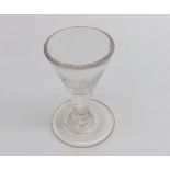 A small 19th Century Firing Glass with funnel bowl on a plain spreading circular foot, 2 ¾” high