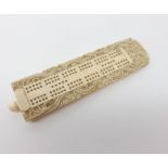 A carved Ivory Cribbage Scoreboard, button handle and the border carved with dragons, 6” long