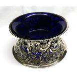 A late Victorian silver and Bristol blue glass lined Potato Ring, the pierced side is elaborately