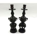 A pair of Oriental Bronze finish Candlesticks, the bulbous stems decorated with various dragons,